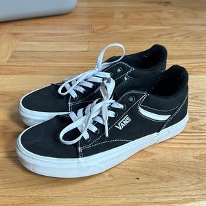 Women’s black and white Vans sneakers
